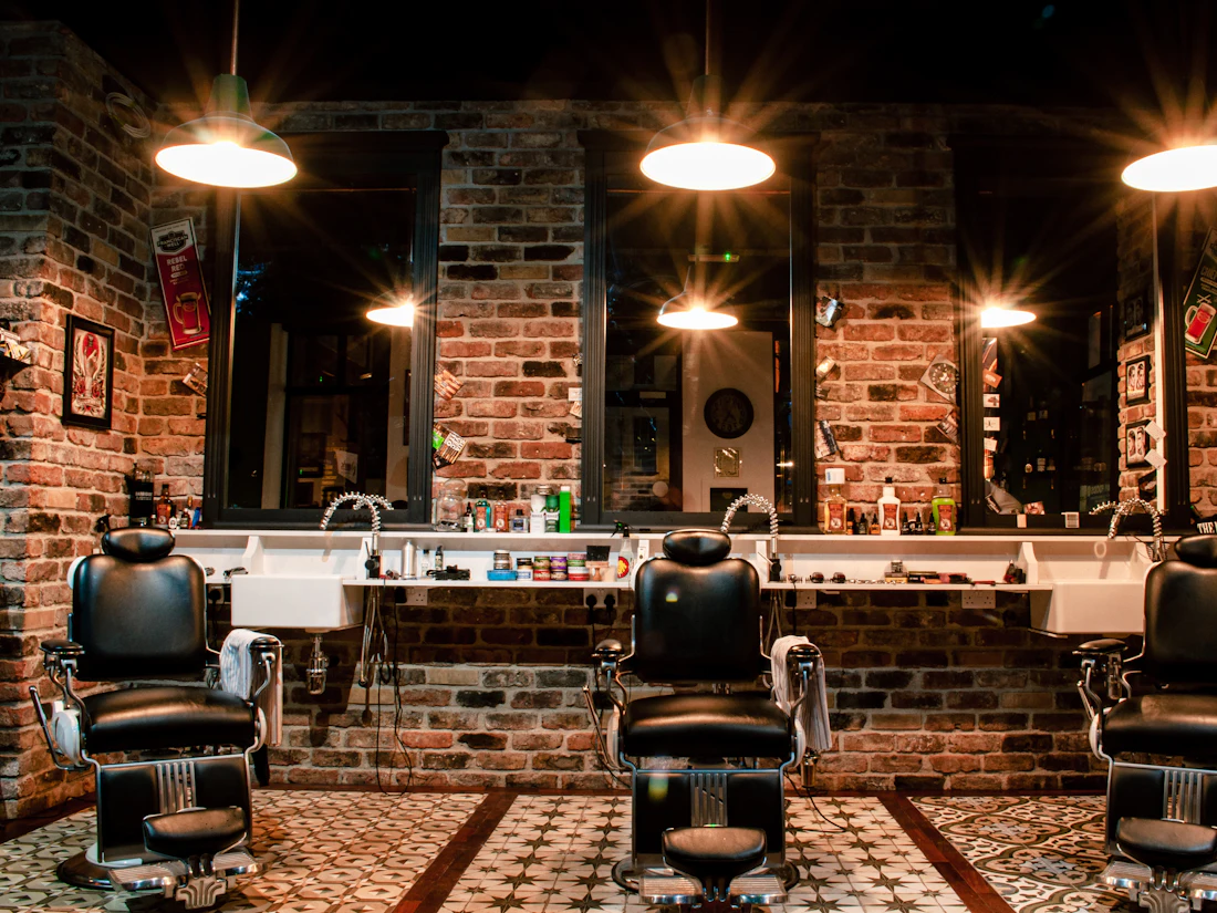 Inside the barbershop with leather chairs and warm lighting